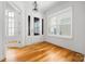 Bright foyer featuring hardwood floors, large windows, and a stylish light fixture at 3008 Laney Pond Rd, Matthews, NC 28104