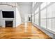 Bright, open living room with hardwood floors, fireplace, and ample natural light from large windows at 3008 Laney Pond Rd, Matthews, NC 28104