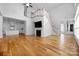 Open-concept space with hardwood floors, a fireplace, and seamless flow between the living area and kitchen at 3008 Laney Pond Rd, Matthews, NC 28104
