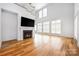 Bright, open living room with hardwood floors, a fireplace, and an abundance of natural light at 3008 Laney Pond Rd, Matthews, NC 28104