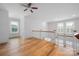 Open loft area with hardwood floors, white railings, and bright natural light at 3008 Laney Pond Rd, Matthews, NC 28104