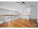 Spacious loft with hardwood floors, white railings, and bright natural light at 3008 Laney Pond Rd, Matthews, NC 28104