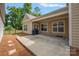 Covered patio features concrete, ceiling fan, neutral paint and access to the backyard at 3008 Laney Pond Rd, Matthews, NC 28104