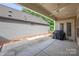 Covered patio features concrete, ceiling fan, neutral paint and access to the backyard at 3008 Laney Pond Rd, Matthews, NC 28104
