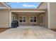 Covered patio features concrete, ceiling fan, neutral paint and access to the backyard at 3008 Laney Pond Rd, Matthews, NC 28104