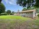 Spacious backyard with lush lawn, mature trees, and a classic brick home at 302 Melinda Ave, Kannapolis, NC 28083