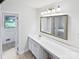 Well-lit bathroom features a bright mirror, vanity, and an enclosed shower at 302 Melinda Ave, Kannapolis, NC 28083