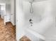 Bathroom featuring bathtub with shower head and white tiled walls at 302 Melinda Ave, Kannapolis, NC 28083