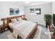 A bedroom features a large bed, two windows, and neutral decor at 302 Melinda Ave, Kannapolis, NC 28083