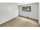 Bright bedroom featuring neutral walls, carpet, and double hung windows at 302 Melinda Ave, Kannapolis, NC 28083