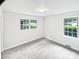 Bright bedroom featuring neutral walls, carpet, and double hung windows at 302 Melinda Ave, Kannapolis, NC 28083