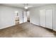 Bright bedroom featuring neutral walls, carpet, ceiling fan, and en-suite bath access at 302 Melinda Ave, Kannapolis, NC 28083