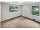Bright bedroom featuring neutral walls, carpet, and double hung windows at 302 Melinda Ave, Kannapolis, NC 28083