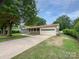 Charming single-story home with an attached garage and a wide driveway at 302 Melinda Ave, Kannapolis, NC 28083