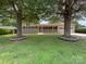 Charming single-story house with a covered porch and lush, mature trees at 302 Melinda Ave, Kannapolis, NC 28083