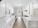Bright galley kitchen with all-white cabinetry and a view to another room at 302 Melinda Ave, Kannapolis, NC 28083