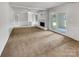 A spacious living room with a painted white fireplace and access to an adjacent room and sunroom at 302 Melinda Ave, Kannapolis, NC 28083