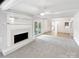 A spacious living room featuring a fireplace with built-in shelving and access to the kitchen at 302 Melinda Ave, Kannapolis, NC 28083