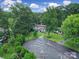 Aerial view of the house with mature trees and a circular driveway on a beautiful lot at 3800 Lovett Cir, Charlotte, NC 28210