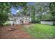 The home features a spacious backyard with a fire pit, shed, trampoline and wooden deck at 3800 Lovett Cir, Charlotte, NC 28210