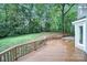 Wooden deck overlooking a lush, landscaped backyard at 3800 Lovett Cir, Charlotte, NC 28210