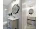 Charming bathroom featuring a modern vanity, decorative mirror, and tiled shower at 3800 Lovett Cir, Charlotte, NC 28210