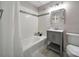 Bright bathroom with a bathtub, tiled walls, modern vanity, and decorative mirror at 3800 Lovett Cir, Charlotte, NC 28210