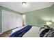 Bedroom with green walls, white trim, and a closet providing ample storage space at 3800 Lovett Cir, Charlotte, NC 28210