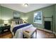 Cozy bedroom with a queen bed, hardwood floors, ample natural light, and stylish decor at 3800 Lovett Cir, Charlotte, NC 28210