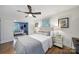 Inviting bedroom with hardwood floors, ceiling fan, and view into a connected living room at 3800 Lovett Cir, Charlotte, NC 28210