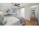 Bright bedroom with wood floors, a sliding barn door and view into the hallway at 3800 Lovett Cir, Charlotte, NC 28210