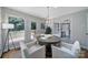 The dining room features large windows, modern light fixture, and access to the outdoor deck at 3800 Lovett Cir, Charlotte, NC 28210