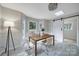 Sunlit dining area with a modern light fixture, sleek dining table, and a barn door at 3800 Lovett Cir, Charlotte, NC 28210