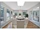 Bright dining room features a round table, stylish chandelier, and views of the outdoors at 3800 Lovett Cir, Charlotte, NC 28210