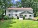 Charming two-story home with a manicured lawn and mature trees offering great curb appeal at 3800 Lovett Cir, Charlotte, NC 28210