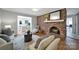Inviting living room with brick fireplace, hardwood floors, and stylish seating arrangements at 3800 Lovett Cir, Charlotte, NC 28210