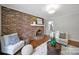 Bright living room with hardwood floors, brick fireplace, and comfortable seating for guests at 3800 Lovett Cir, Charlotte, NC 28210