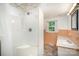 Bathroom featuring a shower and vanity with a small window at 409 Edgewood Ct, Lancaster, SC 29720