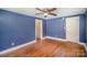 Bedroom with hardwood floors, a ceiling fan, and closet space at 409 Edgewood Ct, Lancaster, SC 29720