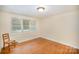 Bright bedroom with hardwood floors and large window with blinds at 409 Edgewood Ct, Lancaster, SC 29720
