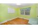 Cozy bedroom with hard wood floors and flamingo themed curtains at 409 Edgewood Ct, Lancaster, SC 29720