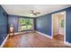 Bedroom with blue walls, hardwood floors and window with view at 409 Edgewood Ct, Lancaster, SC 29720