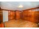 Empty bedroom with wood paneled walls and hardwood floors, awaiting personal touches at 409 Edgewood Ct, Lancaster, SC 29720
