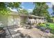 View of the home's exterior with covered patio, showing the home's accessible ramp and concrete tile patio at 409 Edgewood Ct, Lancaster, SC 29720