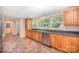 Open kitchen with stainless steel appliances, sink below large window, and tile flooring at 409 Edgewood Ct, Lancaster, SC 29720