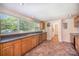 Bright kitchen featuring stainless steel appliances, double sink below a window, and tile flooring at 409 Edgewood Ct, Lancaster, SC 29720