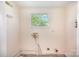 Neutral laundry room with tile floors, a small window, and utility hookups at 409 Edgewood Ct, Lancaster, SC 29720