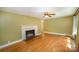 Living room features hardwood floors, a fireplace, and natural light at 409 Edgewood Ct, Lancaster, SC 29720