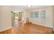 Open floorplan with hardwood floors connecting the living room and dining area at 409 Edgewood Ct, Lancaster, SC 29720