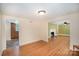 Open concept living and dining room with hardwood flooring, natural lighting, and neutral walls at 409 Edgewood Ct, Lancaster, SC 29720